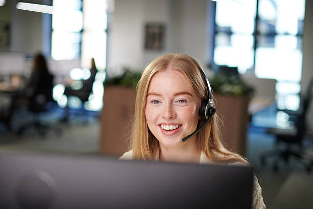 Friendly customer-support agent wearing a headset, smiling at the camera